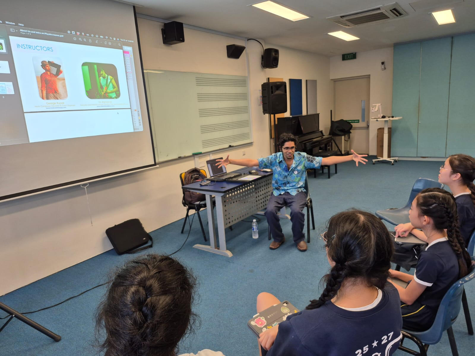 Music Workshop Singapore group listening to a facilitator in a music‑based team‑building workshop in Singapore